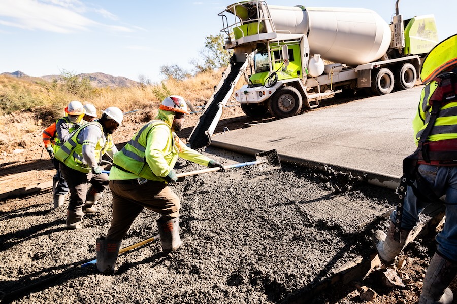 Team members spreading concrete
